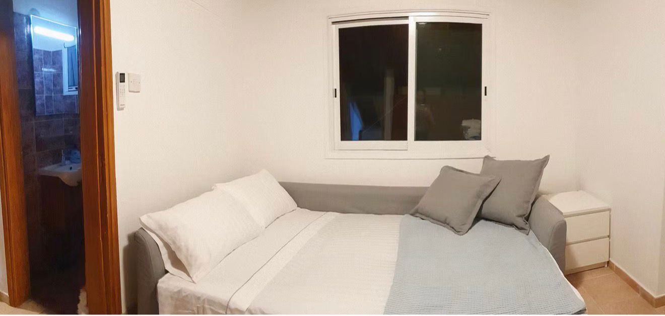 Living room with TV and balcony access