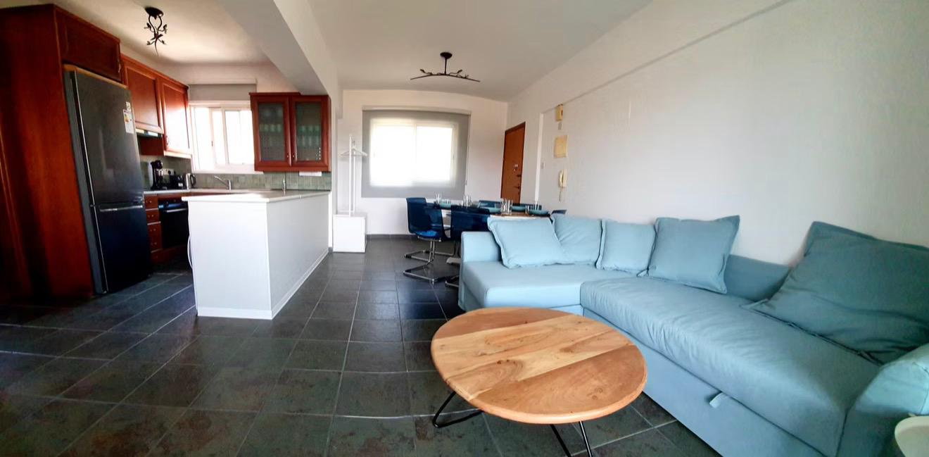 Open-plan living room and kitchen in Larnaca apartment