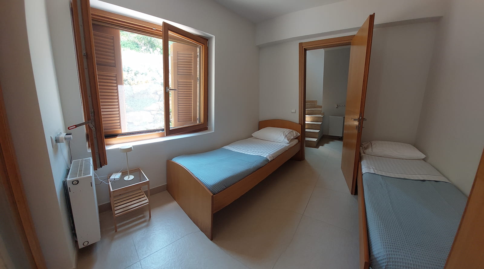 Twin bedroom with wooden shutters