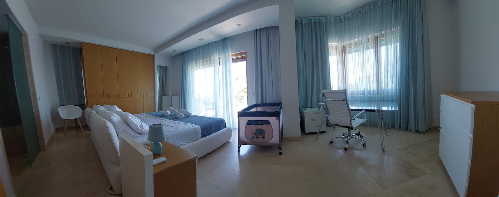 Master suite with balcony views and baby cot