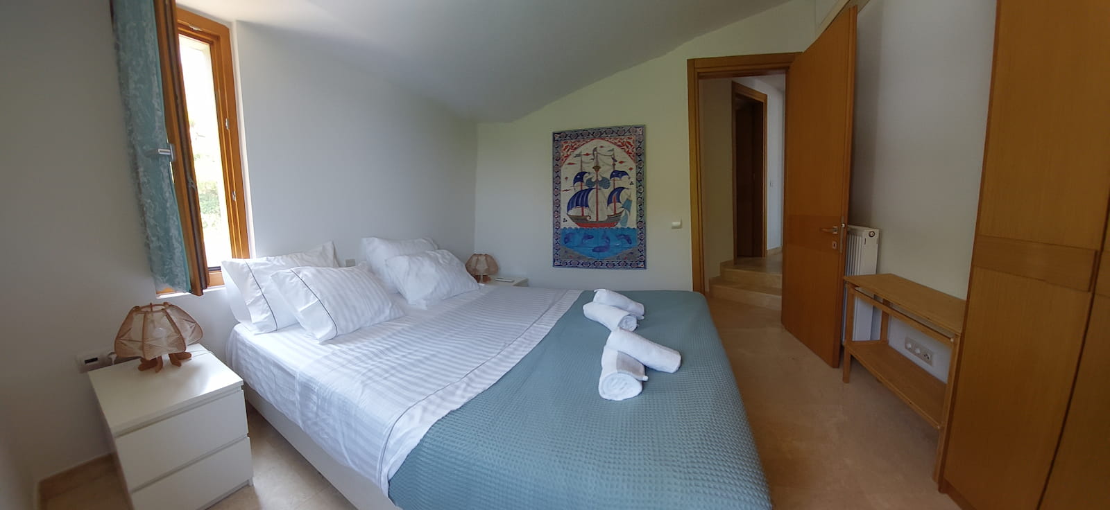 Double bedroom with ship painting