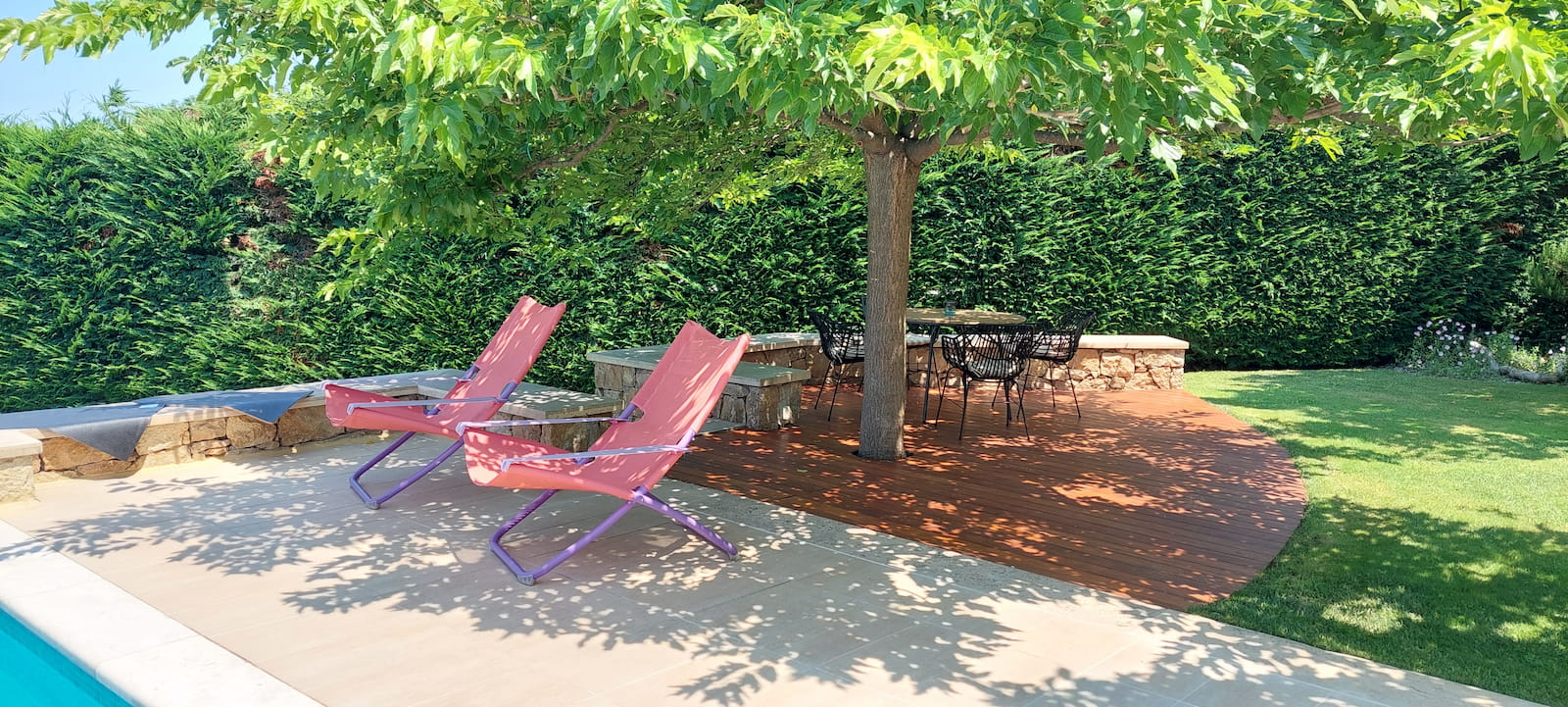 Garden deck with chairs under the trees