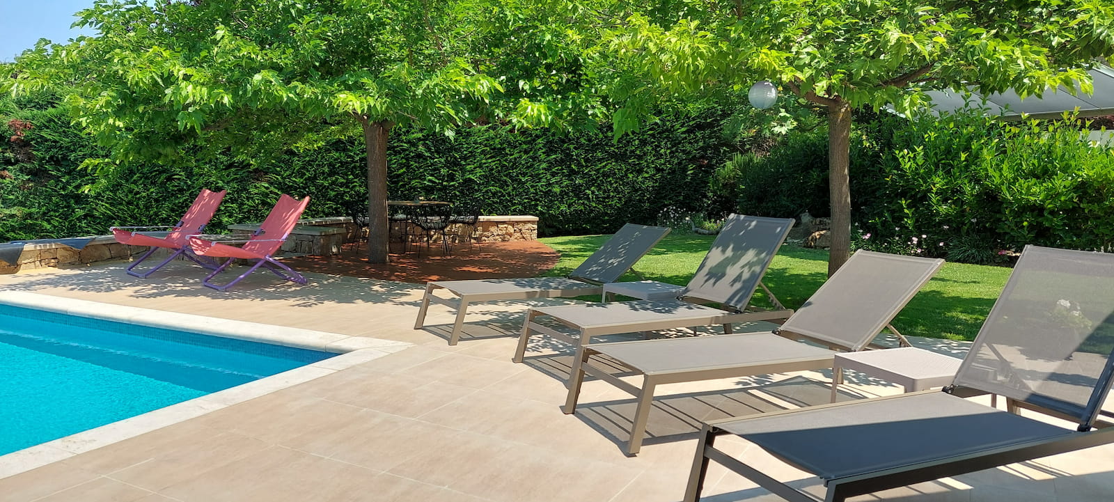 Poolside sun loungers and garden